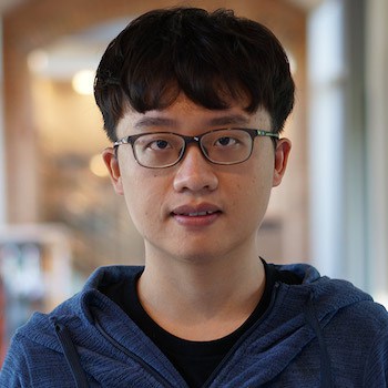 Zhongzhu Chen smiles and poses for a portrait.