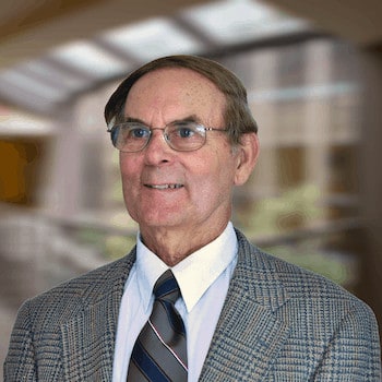 James M. Miller smiles and poses for a portrait.