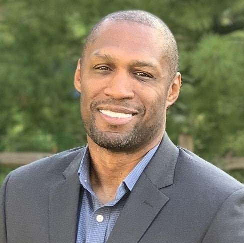 Cornelius Wright smiles and poses for a portrait.