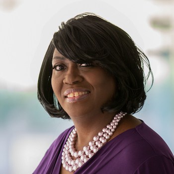 Valerie Martin smiles and poses for a portrait.