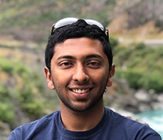 Bevin Mathew smiles and poses for a portrait