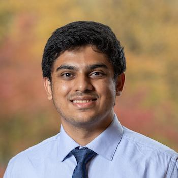 Shreyas Bhat smiles and poses for a portrait.