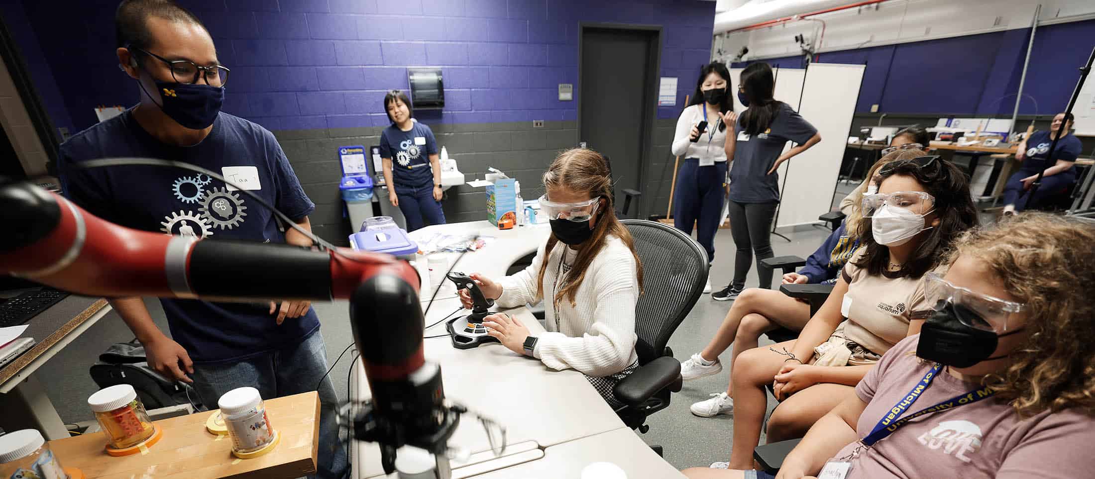 Students use a joy stick while controlling robots