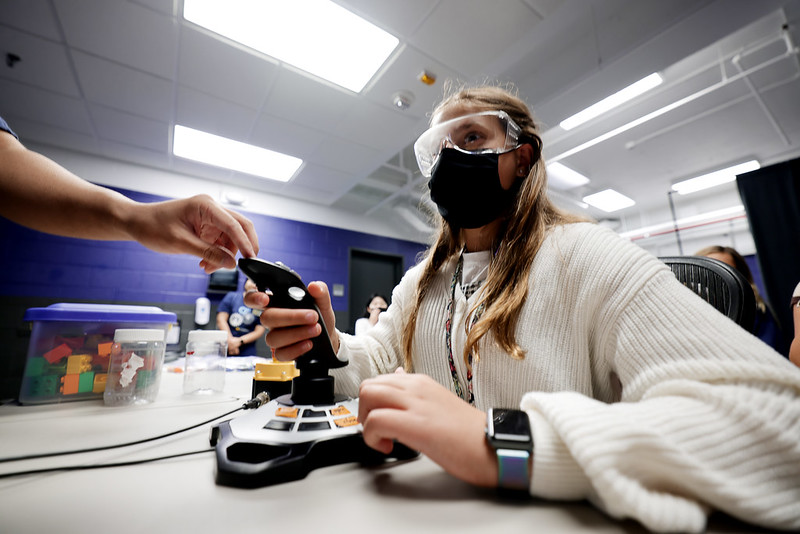 The student controls a shift while testing autonomous vehicle simulation.  