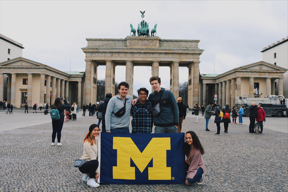 Nick Tran and friends holding up Michigan flag