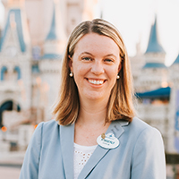 Kimberly Poniatowicz smiles and poses for a portrait in front of Disney Castle