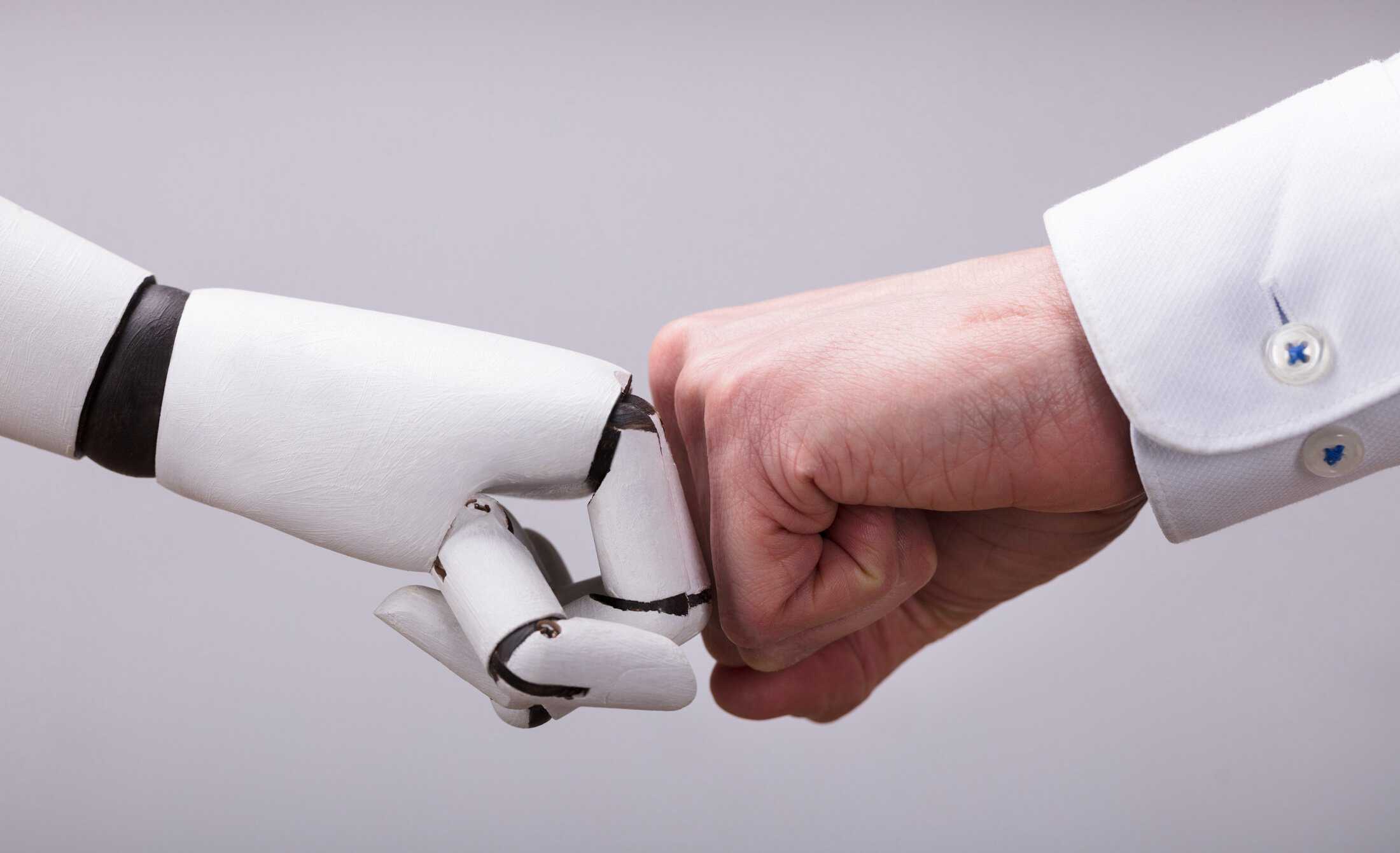 Robot hand fist bumping with a human hand